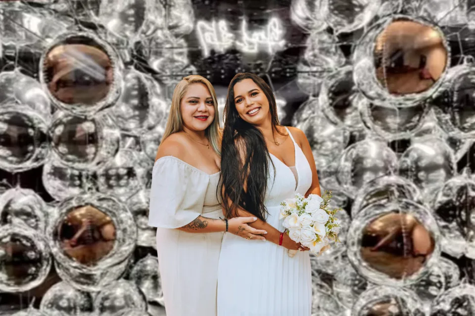 Interactive mirror photo booth with silver balloon backdrop and guests at Dubai wedding celebration