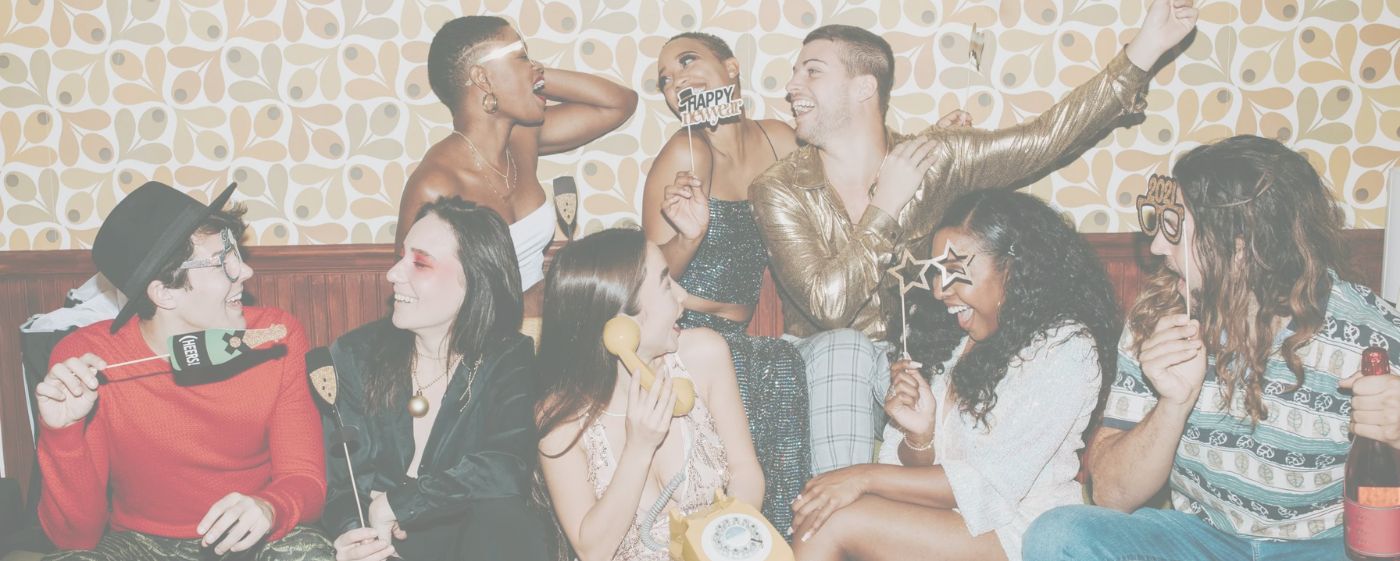 Happy guests enjoying photo booth with props at party