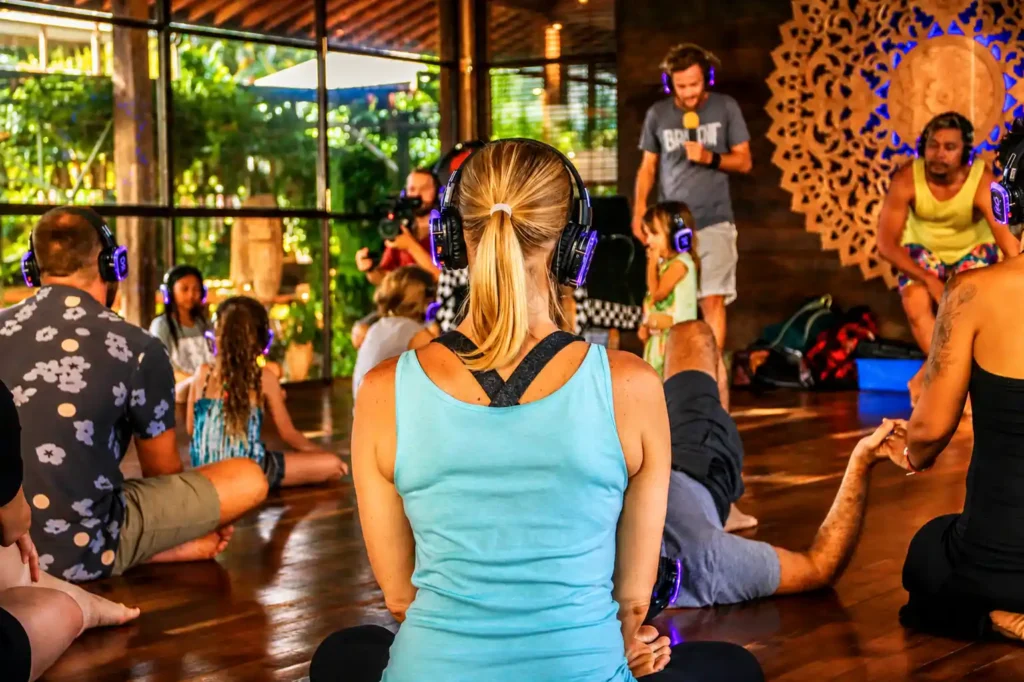 Silent yoga session in Dubai using wireless headphones for an immersive wellness experience