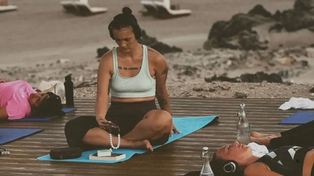Silent yoga Dubai on the beach using silent headset technology for immersive wellness experiences